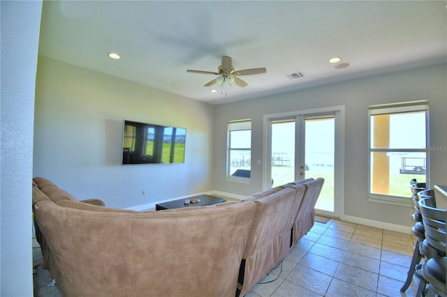 living room with a wealth of natural light, visible vents, baseboards, and recessed lighting