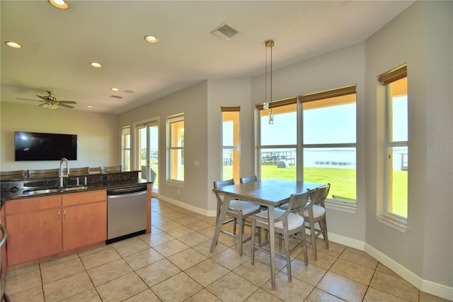 kitchen with stainless steel dishwasher, recessed lighting, baseboards, and a sink