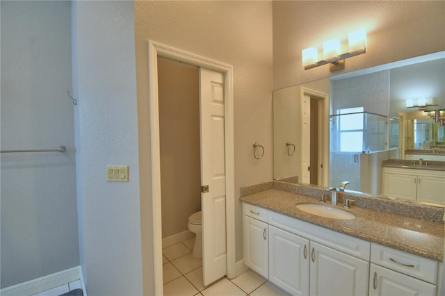 full bathroom with baseboards, a sink, tile patterned flooring, a shower stall, and toilet