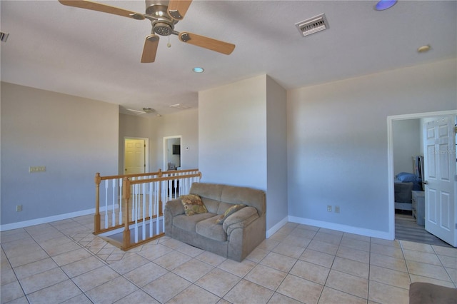 living room featuring light tile patterned flooring, baseboards, and visible vents