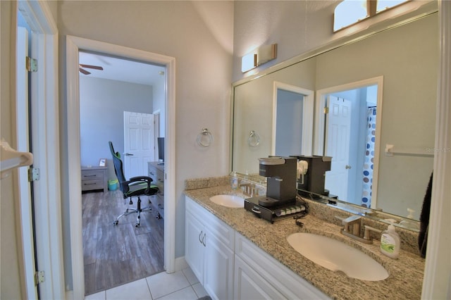 bathroom featuring double vanity, tile patterned flooring, and a sink