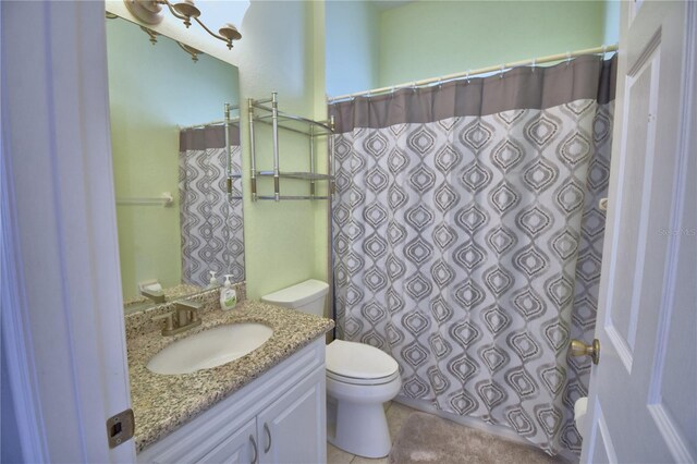 full bath featuring vanity, a shower with shower curtain, toilet, and tile patterned flooring