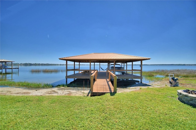 dock area with a yard and a water view