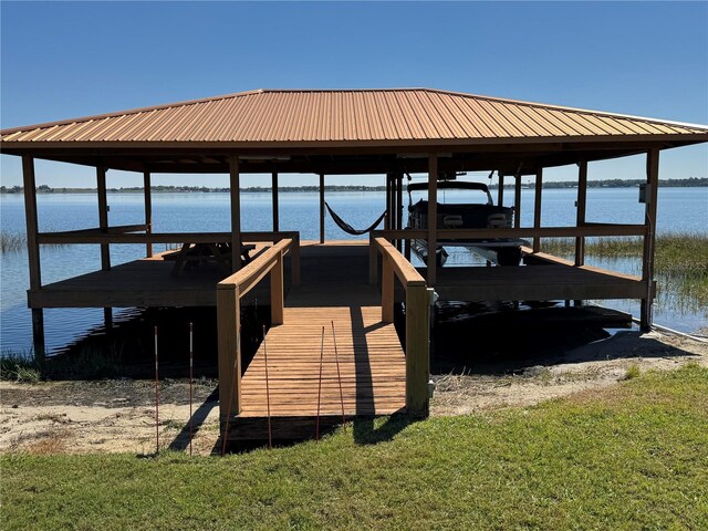 view of dock with boat lift and a water view