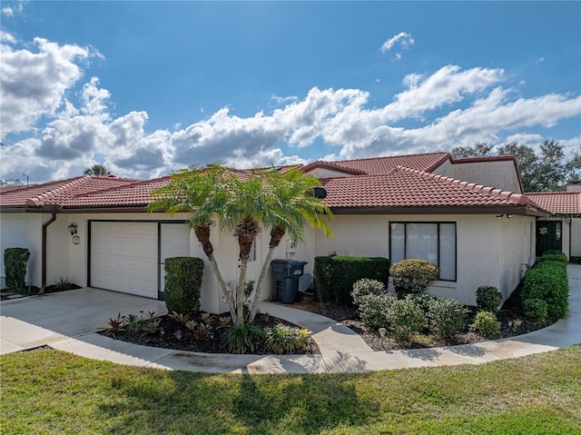 view of front of property featuring a garage and a front lawn