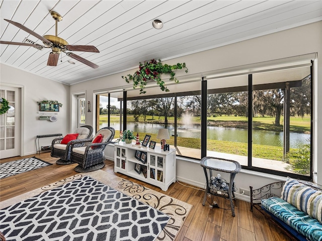 sunroom / solarium featuring wooden ceiling, ceiling fan, and a water view