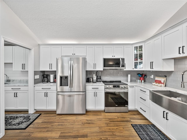 kitchen featuring appliances with stainless steel finishes, sink, and white cabinets