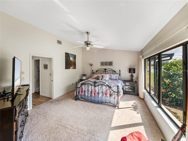 carpeted bedroom featuring vaulted ceiling, access to outside, ceiling fan, and a textured ceiling