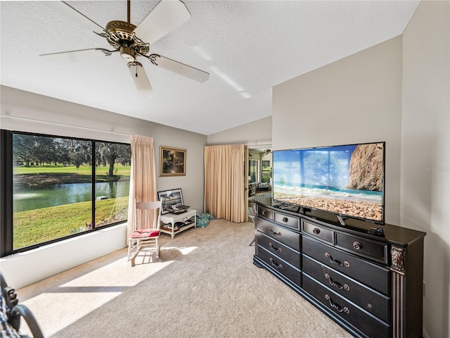 carpeted bedroom with lofted ceiling, ceiling fan, and a textured ceiling