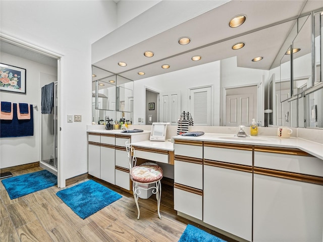 bathroom featuring hardwood / wood-style floors, vanity, and curtained shower