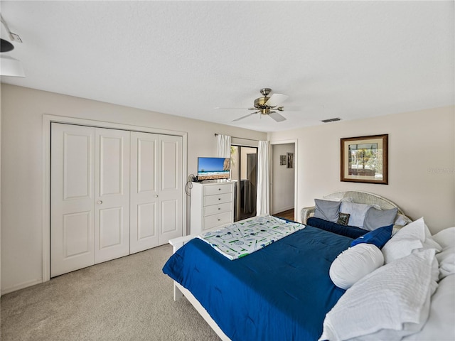 bedroom featuring light colored carpet and ceiling fan