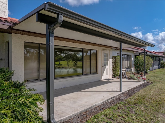 rear view of property featuring a yard and a patio area