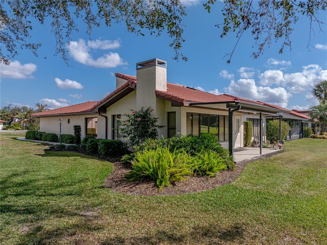 rear view of house featuring a yard and a patio area