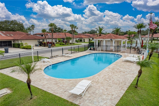 view of swimming pool featuring a lawn and a patio area