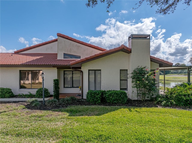 exterior space featuring a front yard and a water view