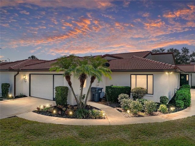 mediterranean / spanish-style home featuring a garage