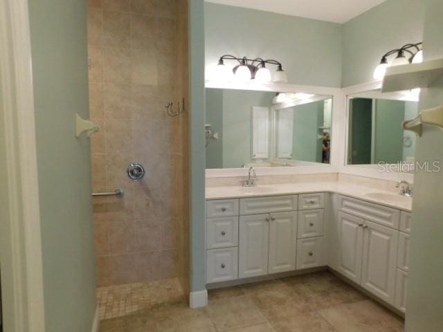 bathroom with vanity, tile patterned floors, and tiled shower