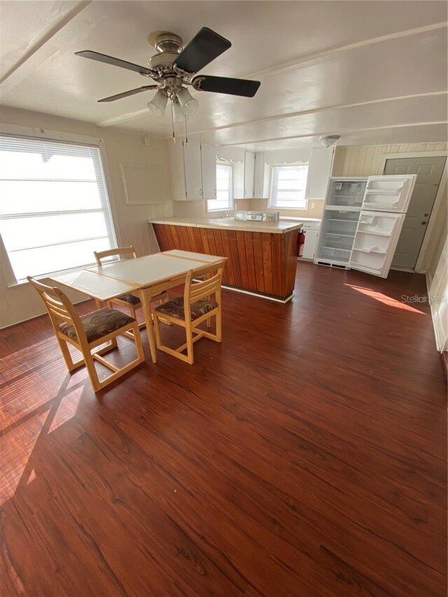 dining area with dark hardwood / wood-style floors and ceiling fan