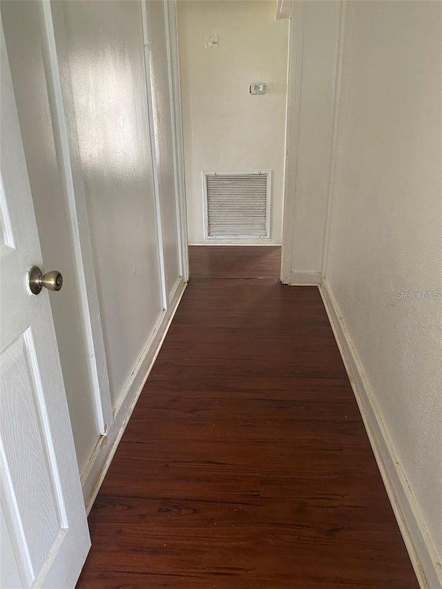 hall with dark hardwood / wood-style floors