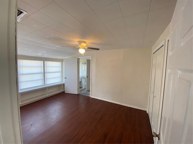 empty room with dark hardwood / wood-style floors and ceiling fan