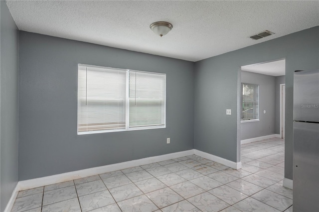 empty room featuring a textured ceiling