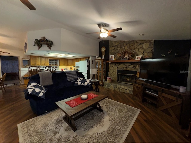 living room with dark wood-style flooring, ceiling fan, and a fireplace