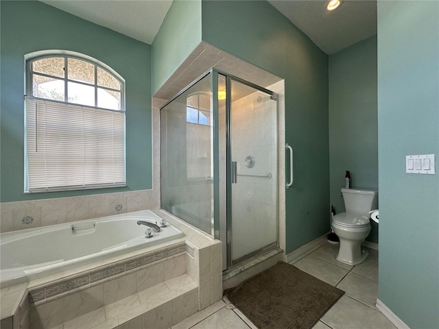 bathroom featuring tile patterned flooring, shower with separate bathtub, and toilet