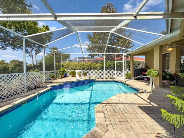 outdoor pool with a patio and a lanai
