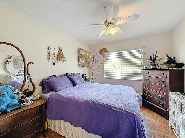 bedroom with wood finished floors and a ceiling fan