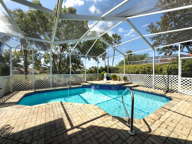 view of swimming pool featuring a patio, glass enclosure, and a fenced in pool