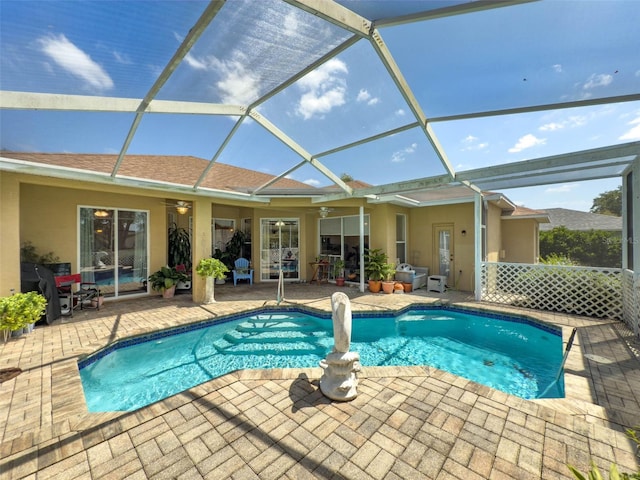 pool with a patio, ceiling fan, and a lanai