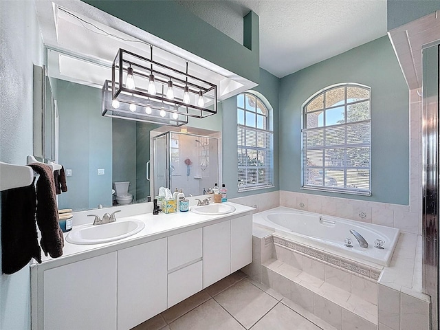 bathroom featuring toilet, a shower stall, a bath, and a sink