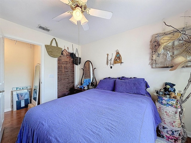 bedroom with visible vents, a ceiling fan, and dark wood finished floors