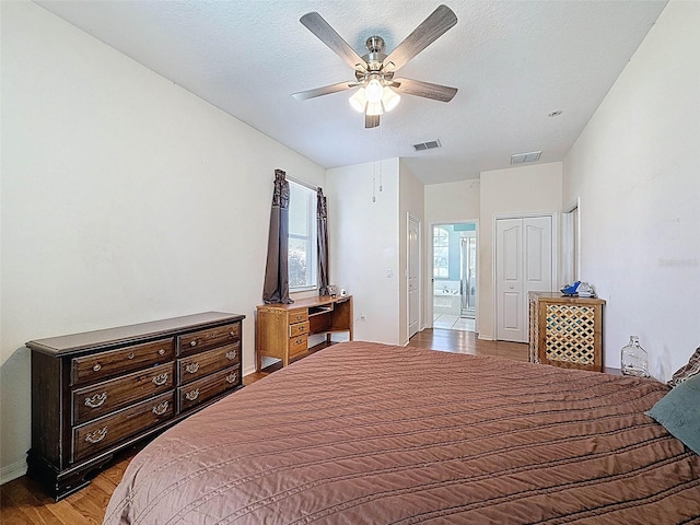 bedroom with visible vents, ceiling fan, wood finished floors, and baseboards
