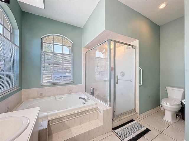 full bath featuring toilet, a bath, a shower stall, and tile patterned floors