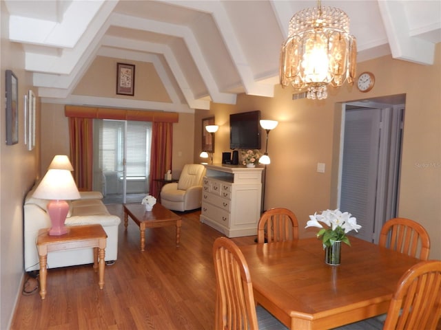 dining space with hardwood / wood-style floors, vaulted ceiling with beams, and a notable chandelier