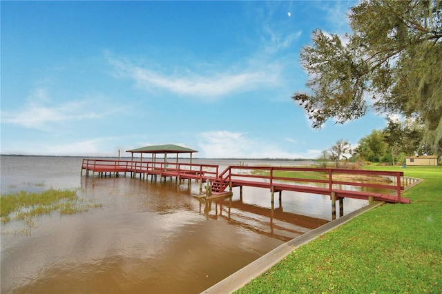 dock area featuring a water view and a lawn