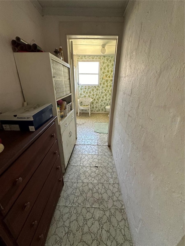 hallway featuring a textured wall