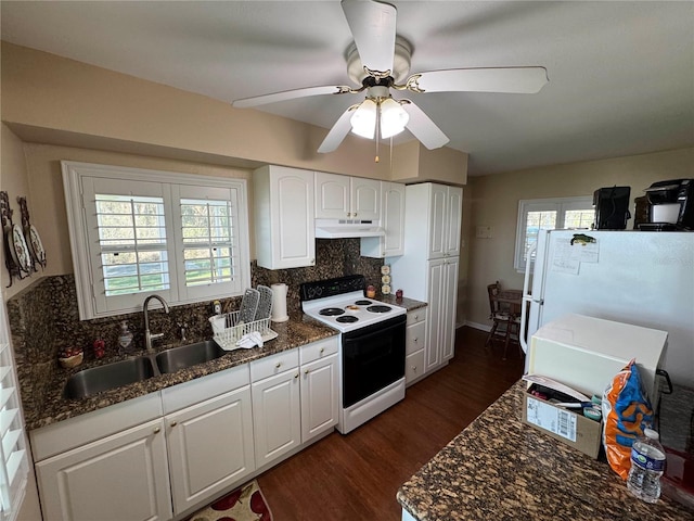 kitchen with tasteful backsplash, electric range oven, freestanding refrigerator, a sink, and under cabinet range hood