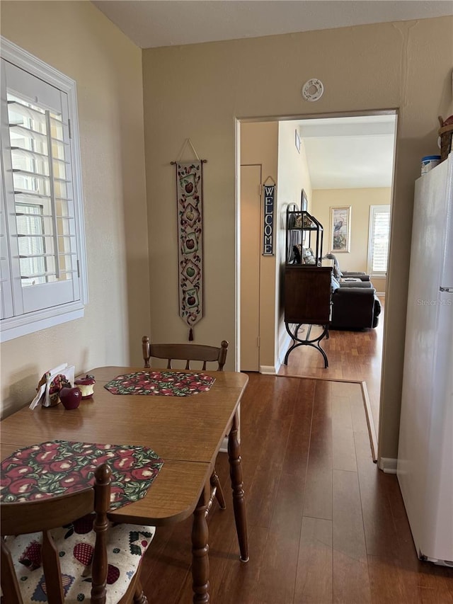 dining area with dark wood finished floors