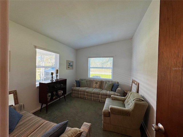 carpeted living room featuring vaulted ceiling, plenty of natural light, and baseboards