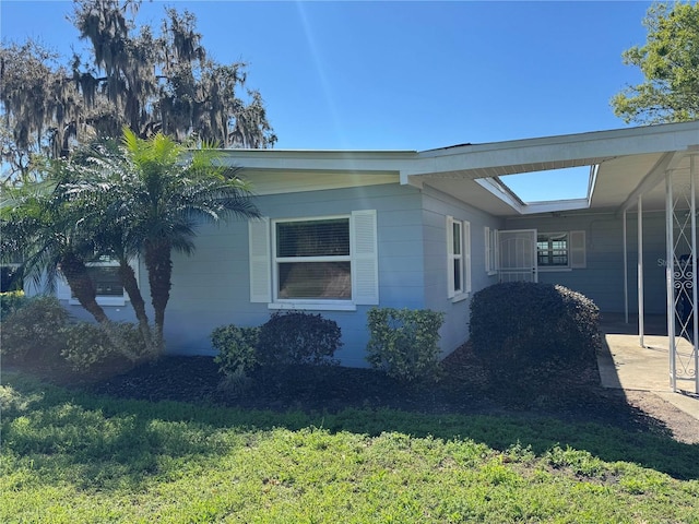 view of side of property with a lawn