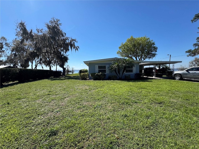 view of yard with an attached carport