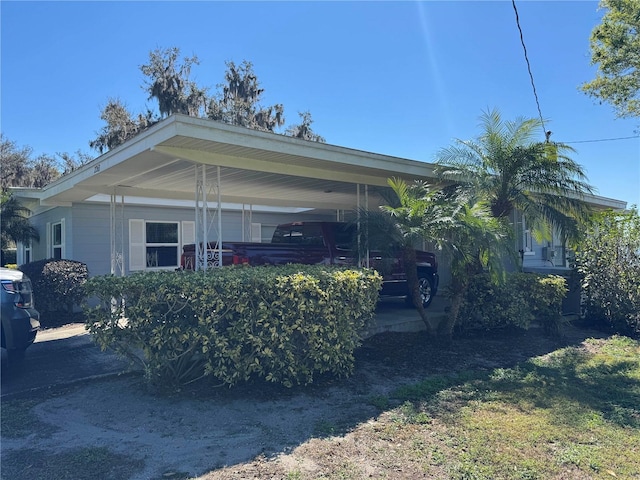 view of side of property with a carport