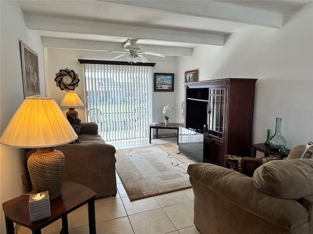 living area with ceiling fan, beamed ceiling, and light tile patterned floors