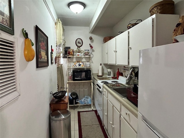 kitchen with light countertops, white appliances, tile patterned flooring, and white cabinets