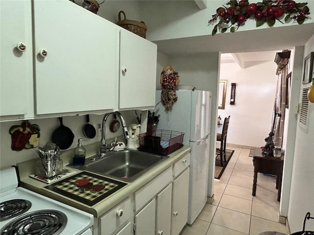 kitchen with light tile patterned floors, white appliances, a sink, white cabinetry, and light countertops