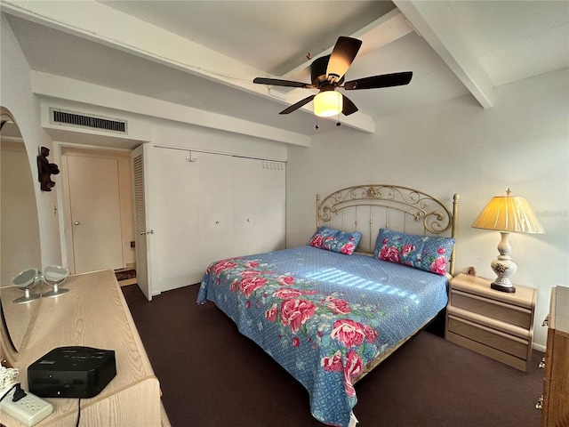 carpeted bedroom featuring a closet, beam ceiling, visible vents, and a ceiling fan