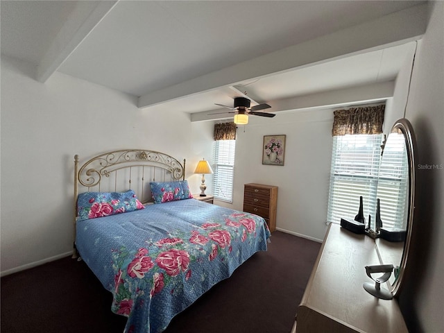 carpeted bedroom with ceiling fan, beam ceiling, and baseboards