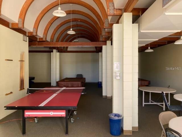 game room with vaulted ceiling